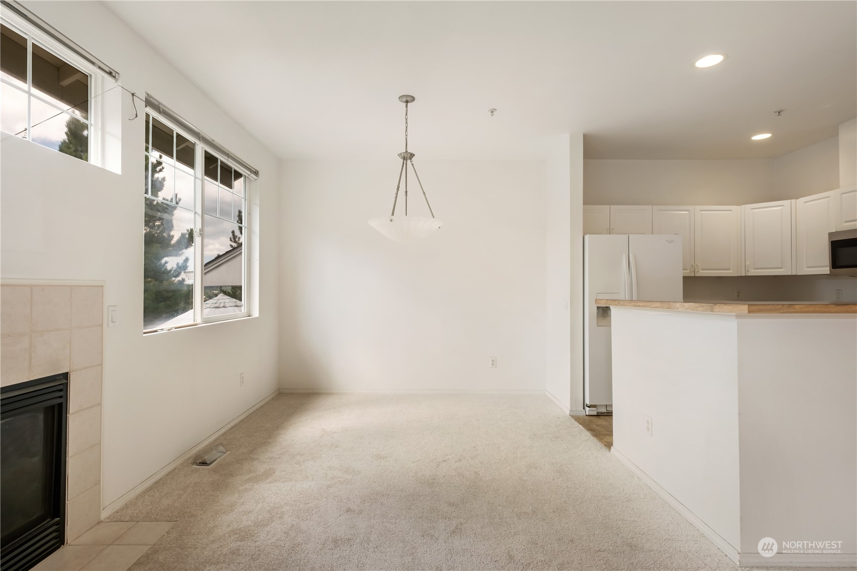 2300 Benson Road South, Unit H1 Renton, WA 98055 - Photo 7 of 27 a view of a kitchen with a sink and a refrigerator
