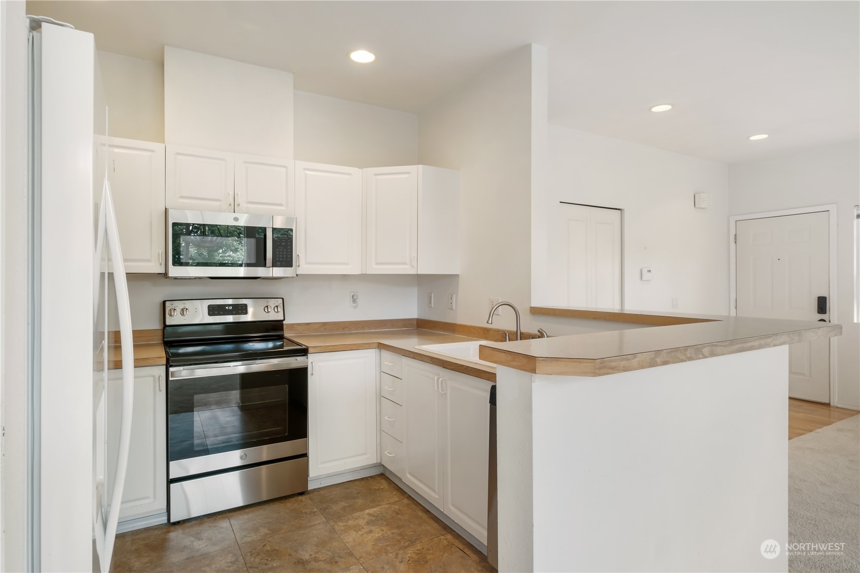 2300 Benson Road South, Unit H1 Renton, WA 98055 - Photo 9 of 27 a kitchen with a sink stove and microwave