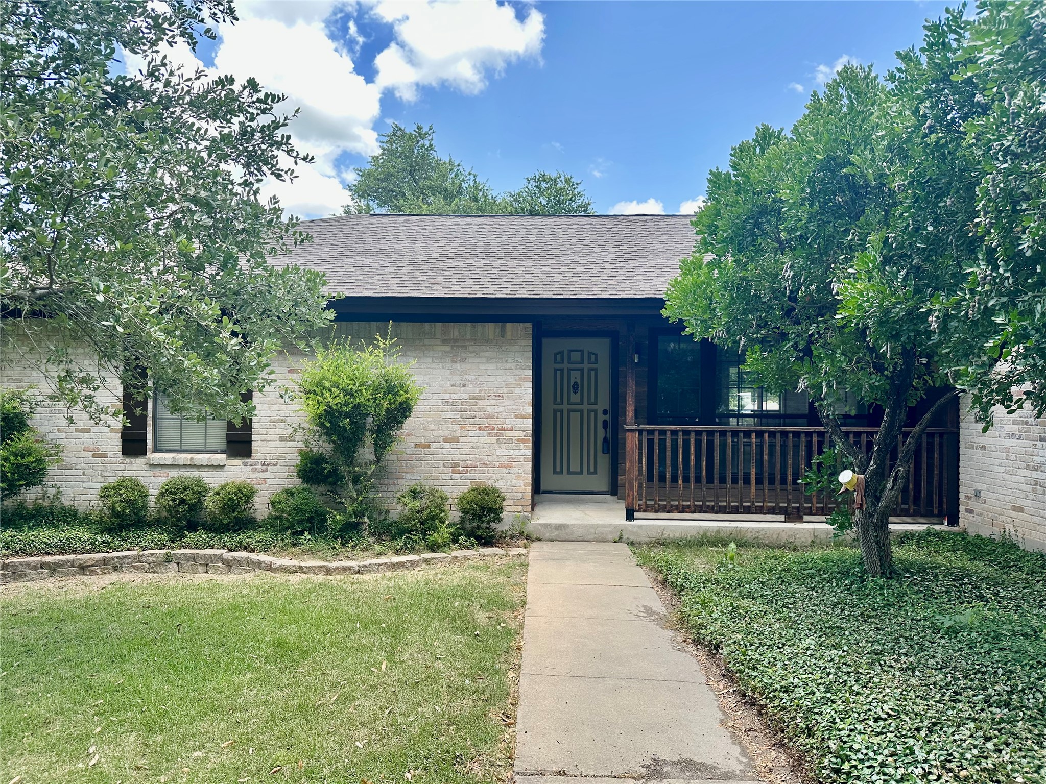 1612 Buttercup Road Pflugerville, TX 78660 - Photo 2 of 16 A well-maintained facade with mature landscaping and a welcoming covered porch.