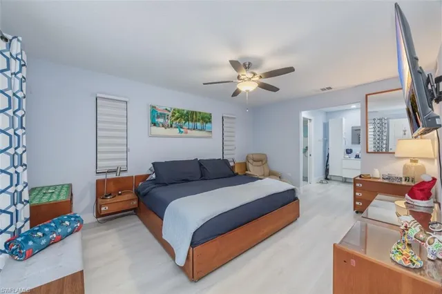 a bedroom with furniture and a chandelier