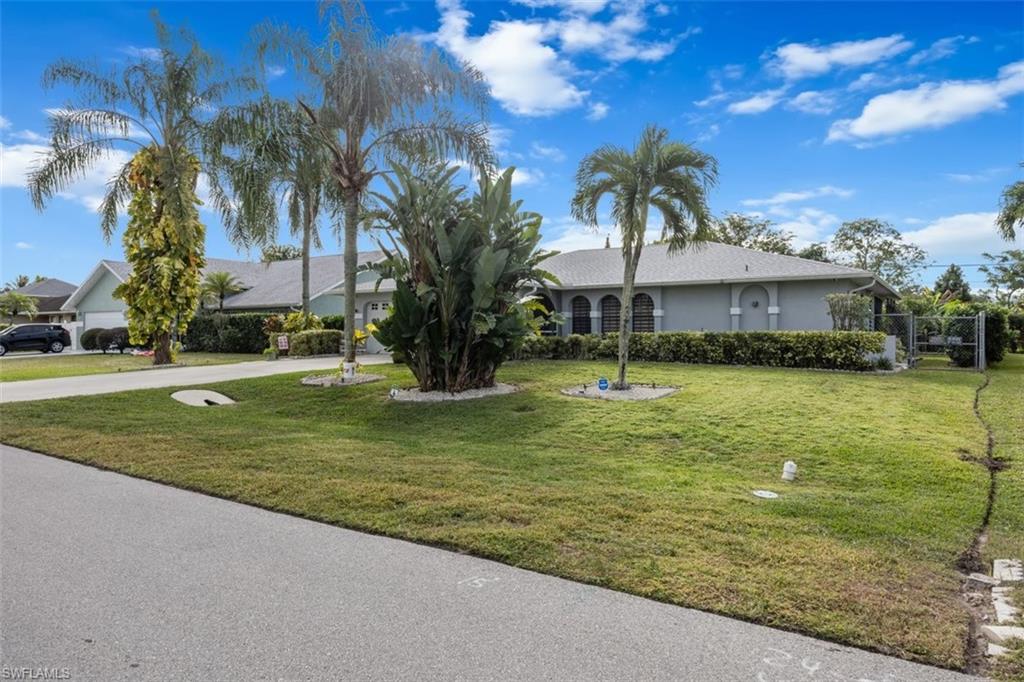 4228 31st Place Southwest Naples, FL 34116 - Photo 2 of 28 a view of a swimming pool with a garden