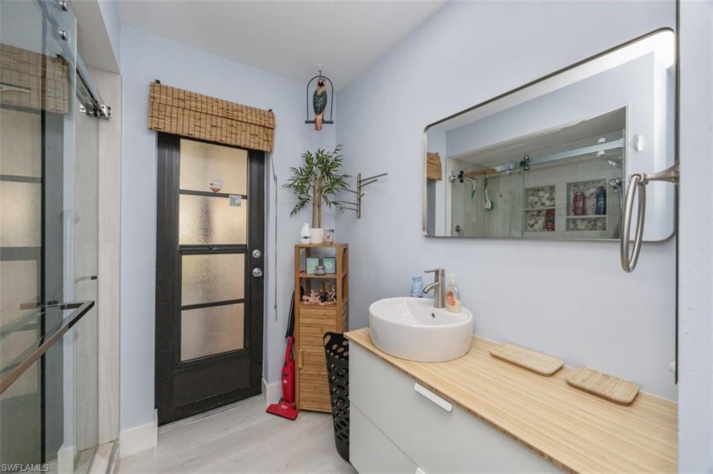4228 31st Place Southwest Naples, FL 34116 - Photo 21 of 28 a bathroom with a sink toilet and shower