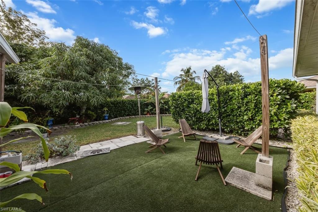 4228 31st Place Southwest Naples, FL 34116 - Photo 25 of 28 a view of a chair and table in the garden