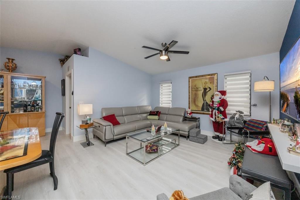 4228 31st Place Southwest Naples, FL 34116 - Photo 10 of 28 a living room with furniture and a flat screen tv