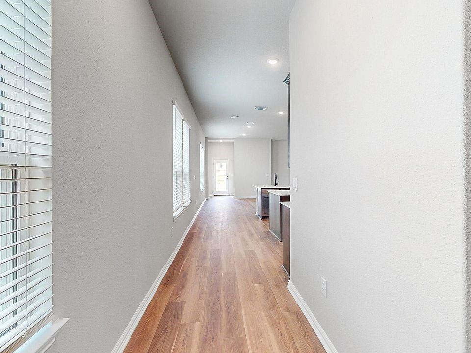 4907 Escape Rivera Drive Austin, TX 78747 - Photo 19 of 28 A long, open entryway guides visitors toward the welcoming kitchen beyond.