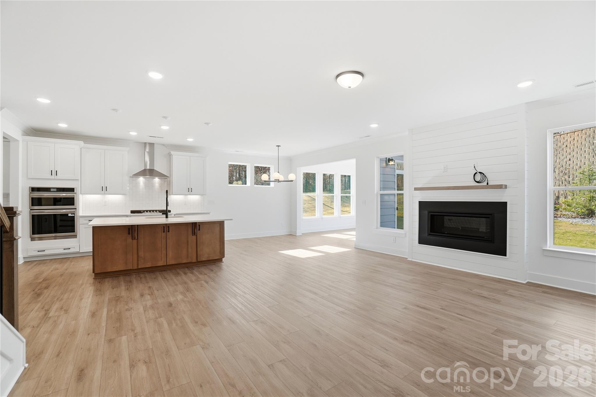 107 Longwood Road Mooresville, NC 28115 - Photo 16 of 43 a living room with furniture and a fireplace