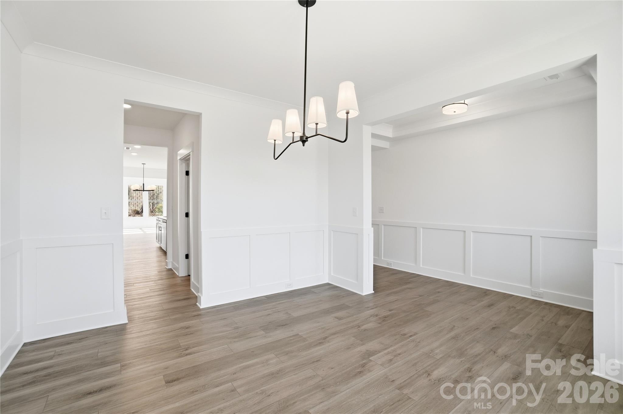 107 Longwood Road Mooresville, NC 28115 - Photo 22 of 43 a view of a room with wooden floor staircase and a kitchen