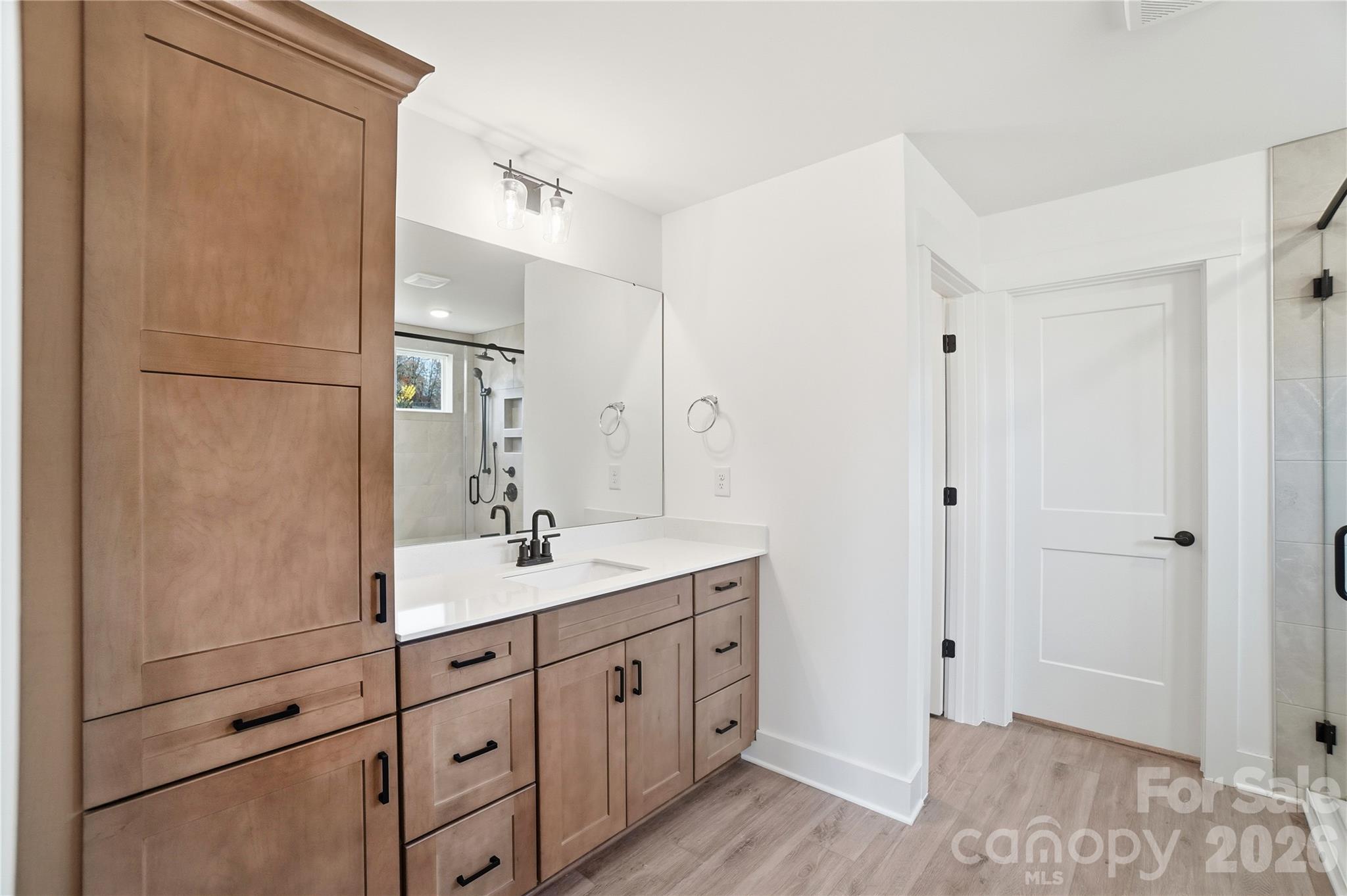 107 Longwood Road Mooresville, NC 28115 - Photo 27 of 43 a spacious bathroom with a double vanity sink a mirror and shower