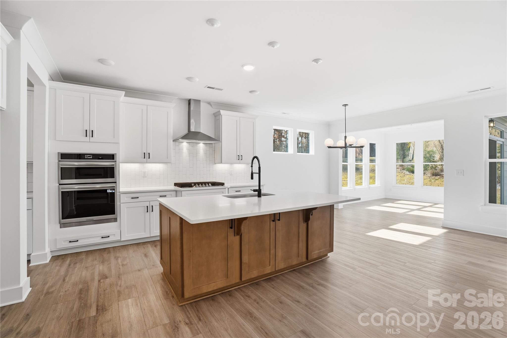 107 Longwood Road Mooresville, NC 28115 - Photo 6 of 43 a kitchen with stainless steel appliances a sink stove and cabinets