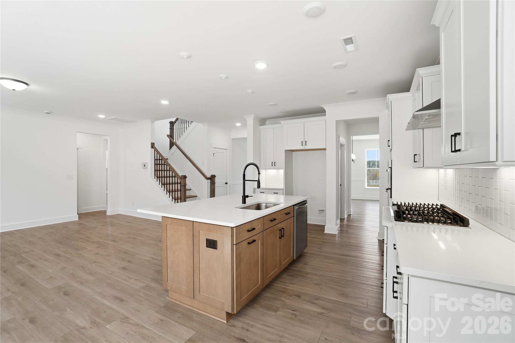 107 Longwood Road Mooresville, NC 28115 - Photo 7 of 43 a kitchen with a sink a refrigerator and a stove