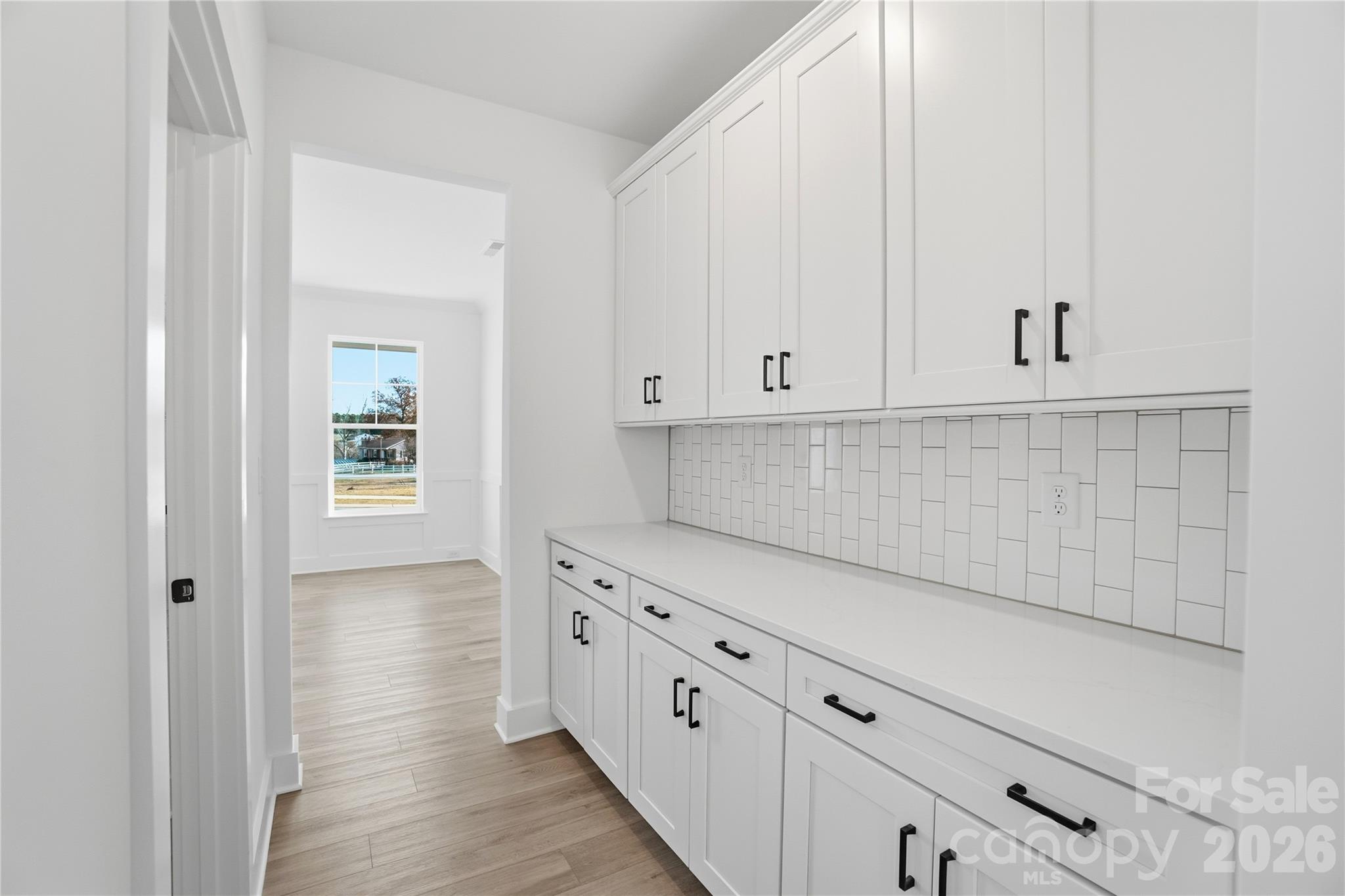 107 Longwood Road Mooresville, NC 28115 - Photo 8 of 43 a kitchen with white cabinets and white appliances