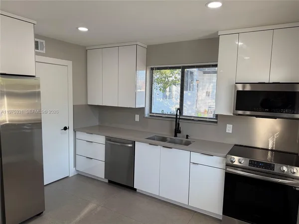a kitchen with a sink stove and microwave