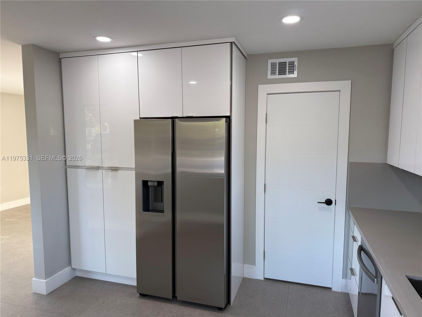 3275 Southwest 27th Street, Unit 3275 Miami, FL 33133 - Photo 6 of 17 a metallic refrigerator freezer sitting in a kitchen