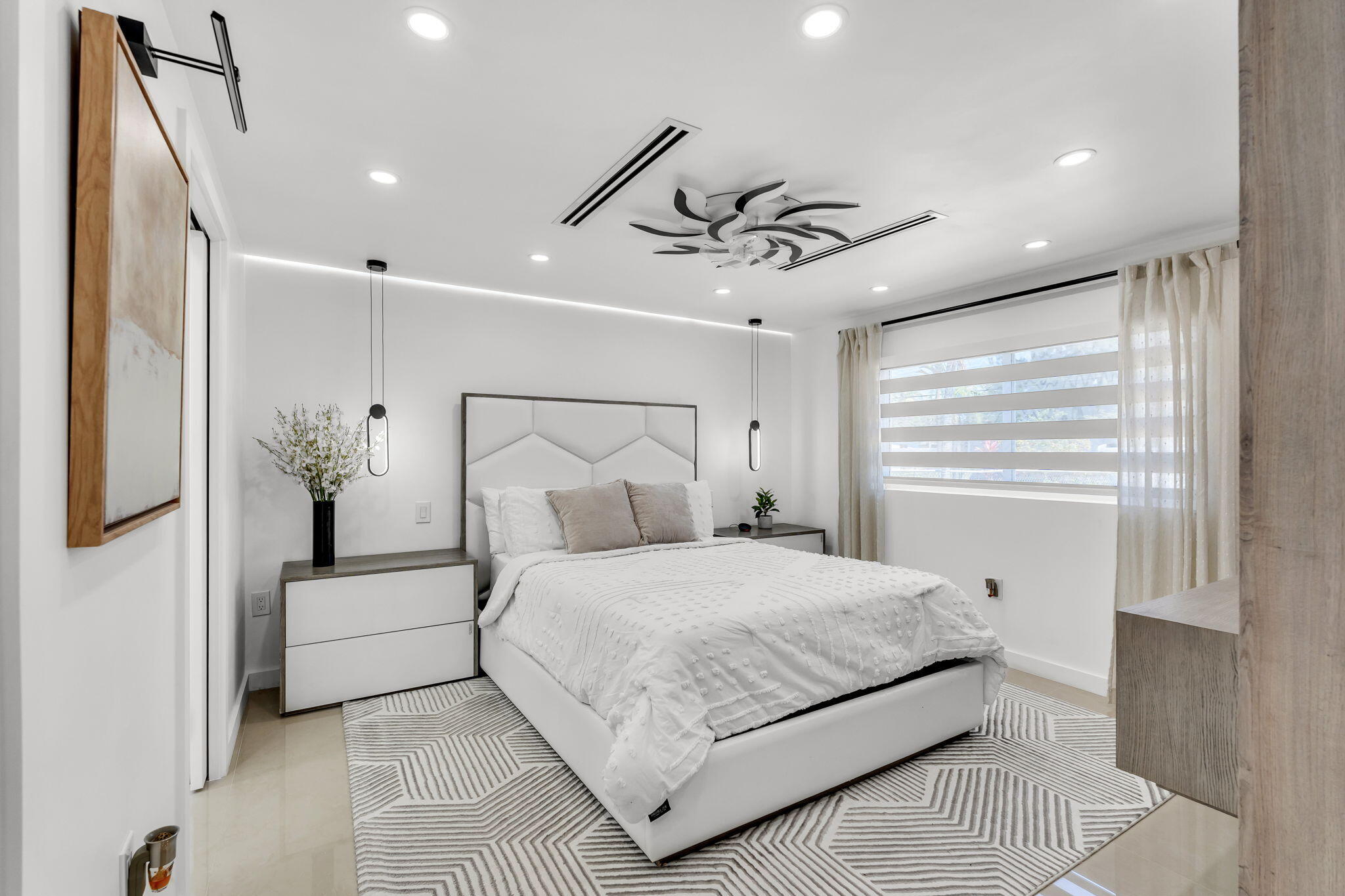 11290 Southwest 48th Street Miami, FL 33165 - Photo 18 of 53 a bedroom with a large bed and a chandelier