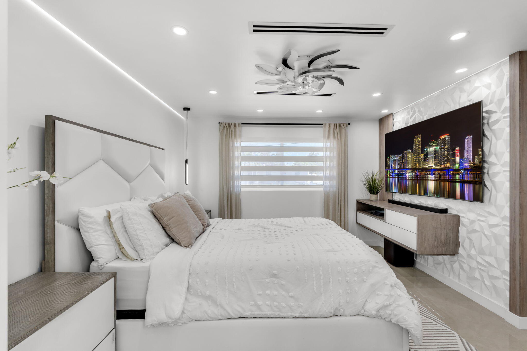 11290 Southwest 48th Street Miami, FL 33165 - Photo 19 of 53 a bedroom with a large bed and paintings on the wall