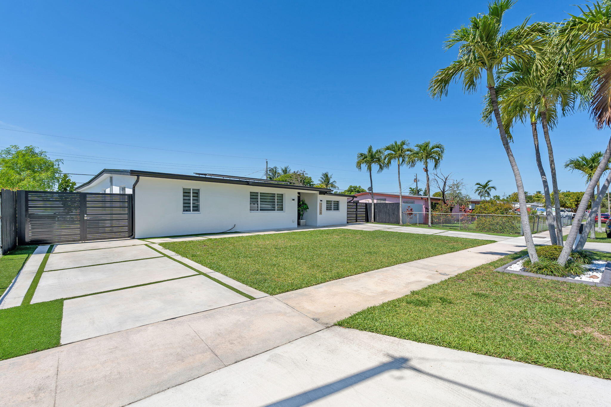 11290 Southwest 48th Street Miami, FL 33165 - Photo 5 of 53 a house with green field in front of it