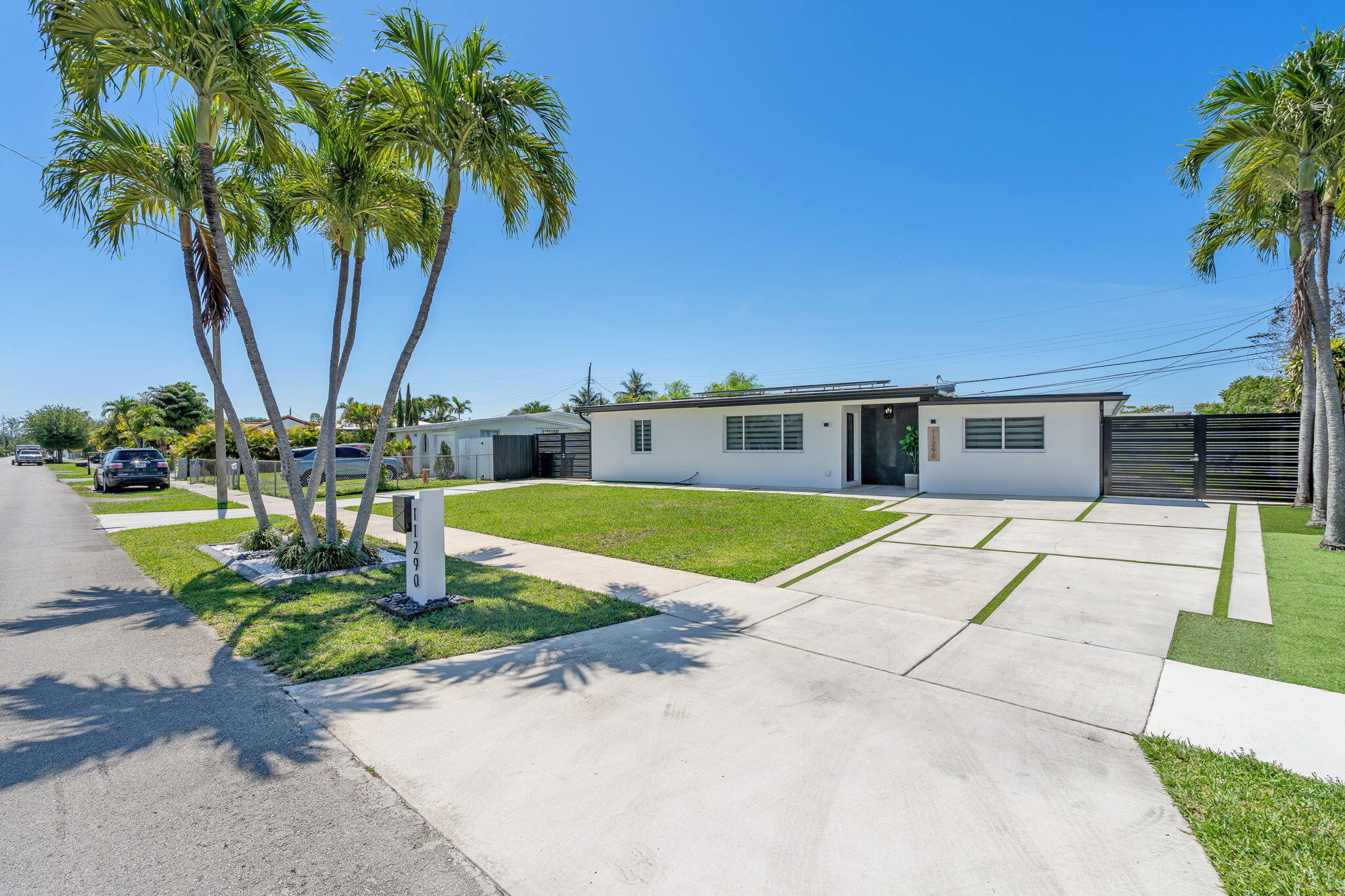 11290 Southwest 48th Street Miami, FL 33165 - Photo 6 of 53 a house with palm tree in front of it
