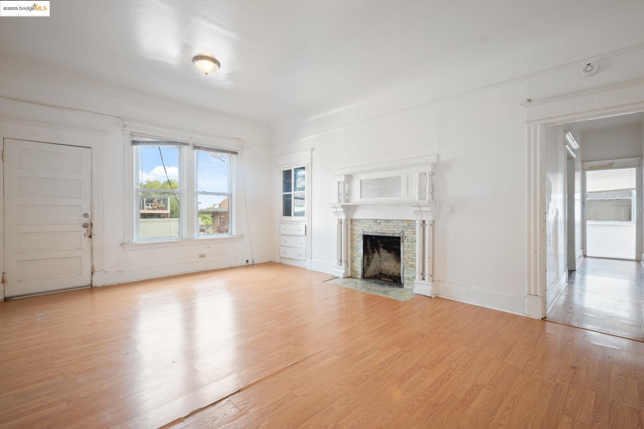 443 Watson Street Monterey, CA 93940 - Photo 4 of 51 Unfurnished living room featuring light wood-style flooring and a fireplace with flush hearth