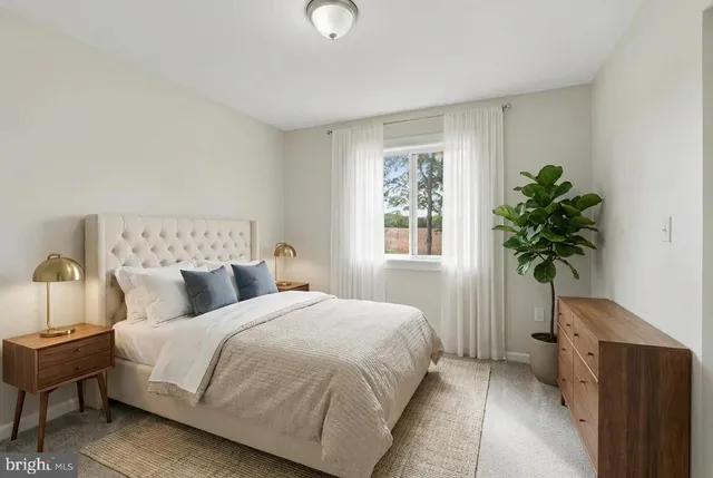 a bedroom with a bed and a potted plant