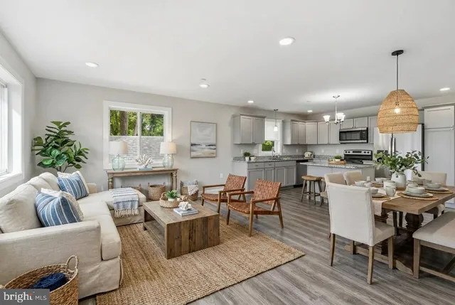 a living room with furniture kitchen and a chandelier
