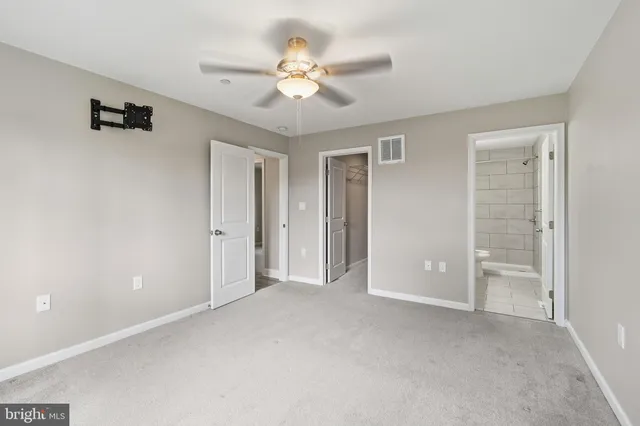 a view of an empty room with a ceiling fan