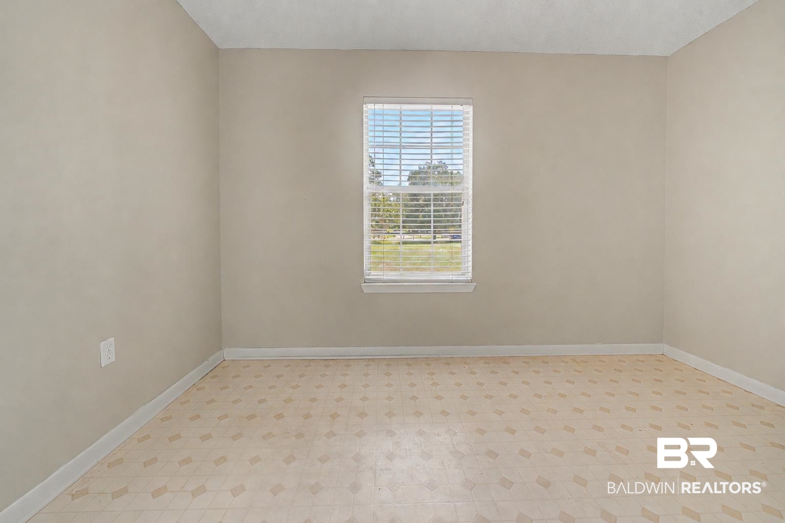 22963 Highway 98 Foley, AL 36535 - Photo 35 of 52 Neutral-toned interior room featuring a single window with blinds and patterned tile flooring