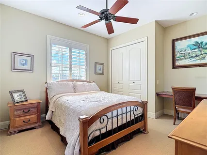 a view of a swimming pool with lounge chairs in front of house