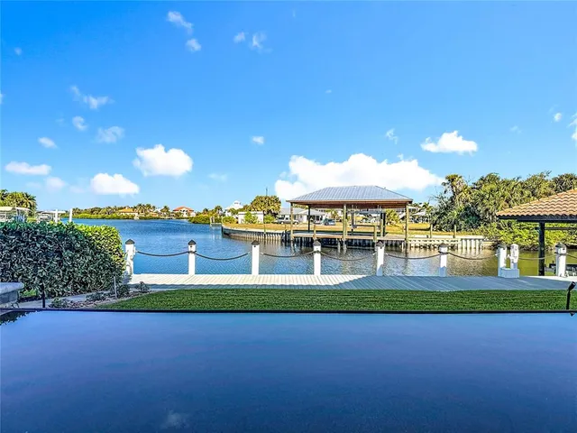 a kitchen with stainless steel appliances granite countertop a sink dishwasher and cabinets with wooden floor