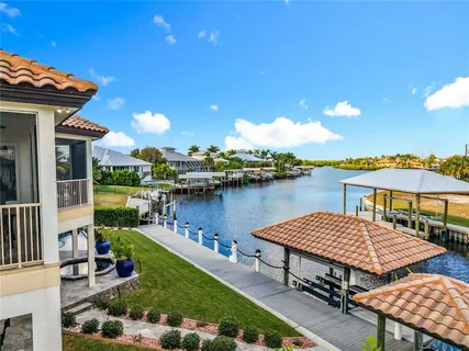 a view of a ocean with boats and trees in the background