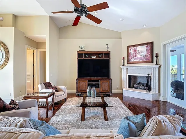 a living room with furniture floor to ceiling window and a table