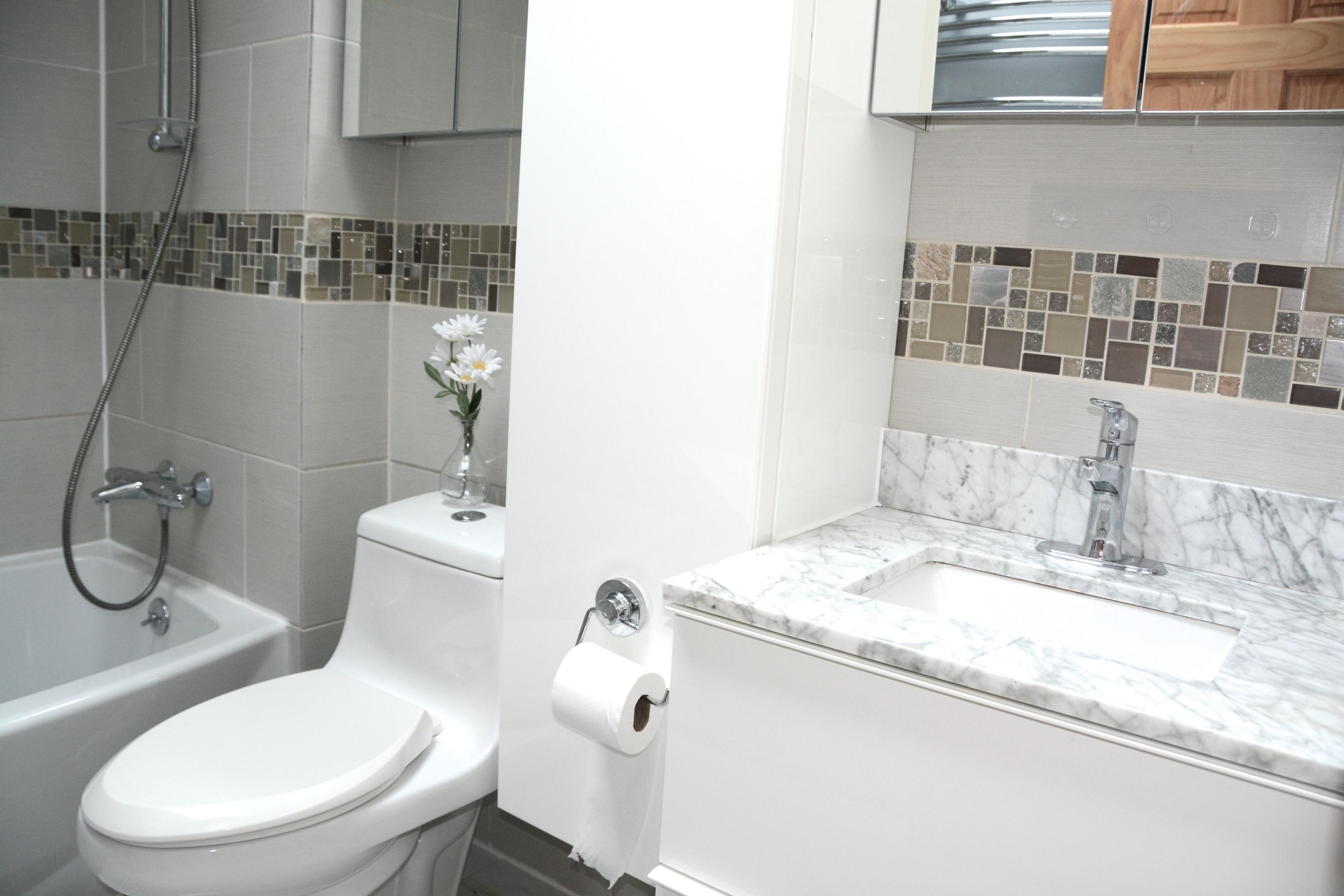 165 Hollow Tree Ridge Road Darien, CT 06820 - Photo 22 of 37 a bathroom with a granite countertop toilet sink and mirror