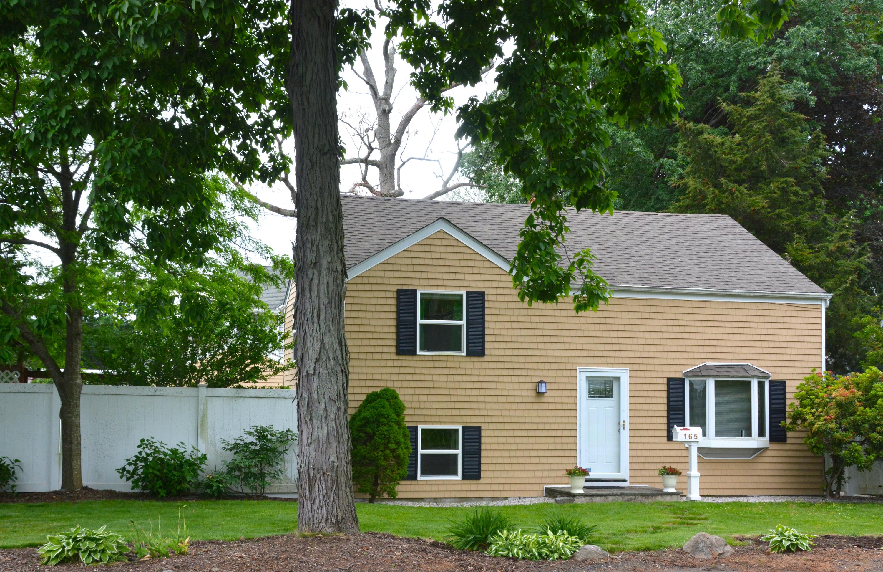 165 Hollow Tree Ridge Road Darien, CT 06820 - Photo 37 of 37 a front view of a house with a yard and garage