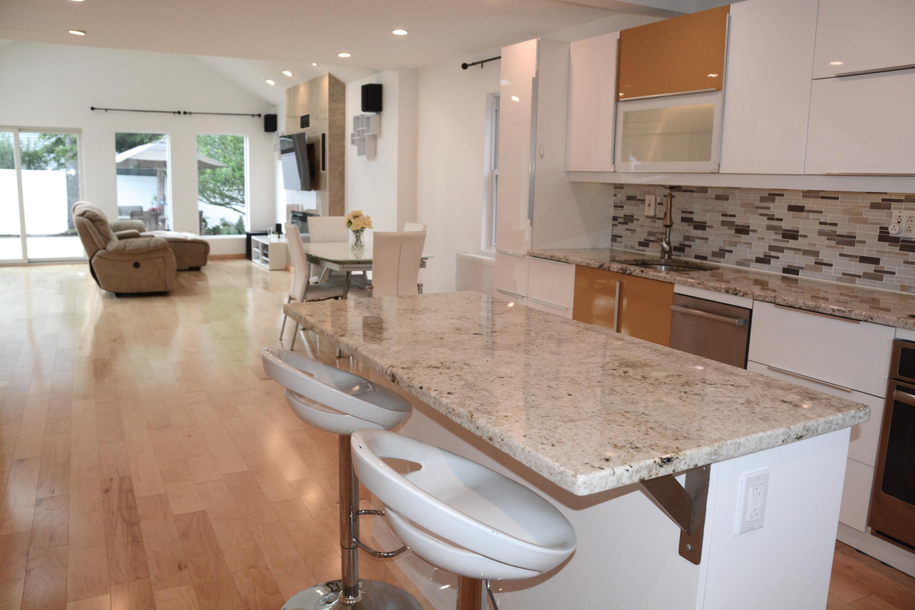 165 Hollow Tree Ridge Road Darien, CT 06820 - Photo 4 of 37 a kitchen with a sink a stove and chairs