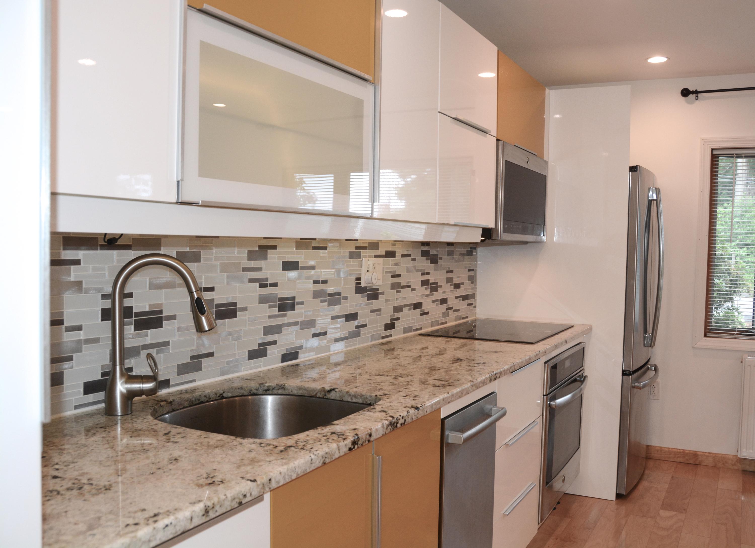 165 Hollow Tree Ridge Road Darien, CT 06820 - Photo 5 of 37 a kitchen with a sink and a refrigerator