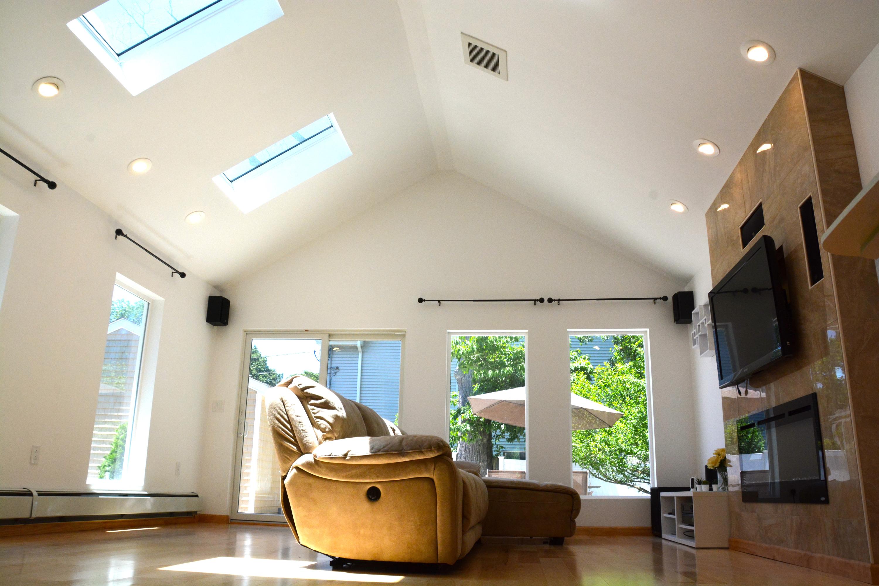 165 Hollow Tree Ridge Road Darien, CT 06820 - Photo 9 of 37 a living room with furniture tv and a large window