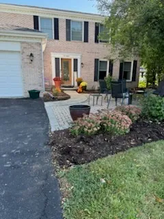 a view of a house with backyard and sitting area