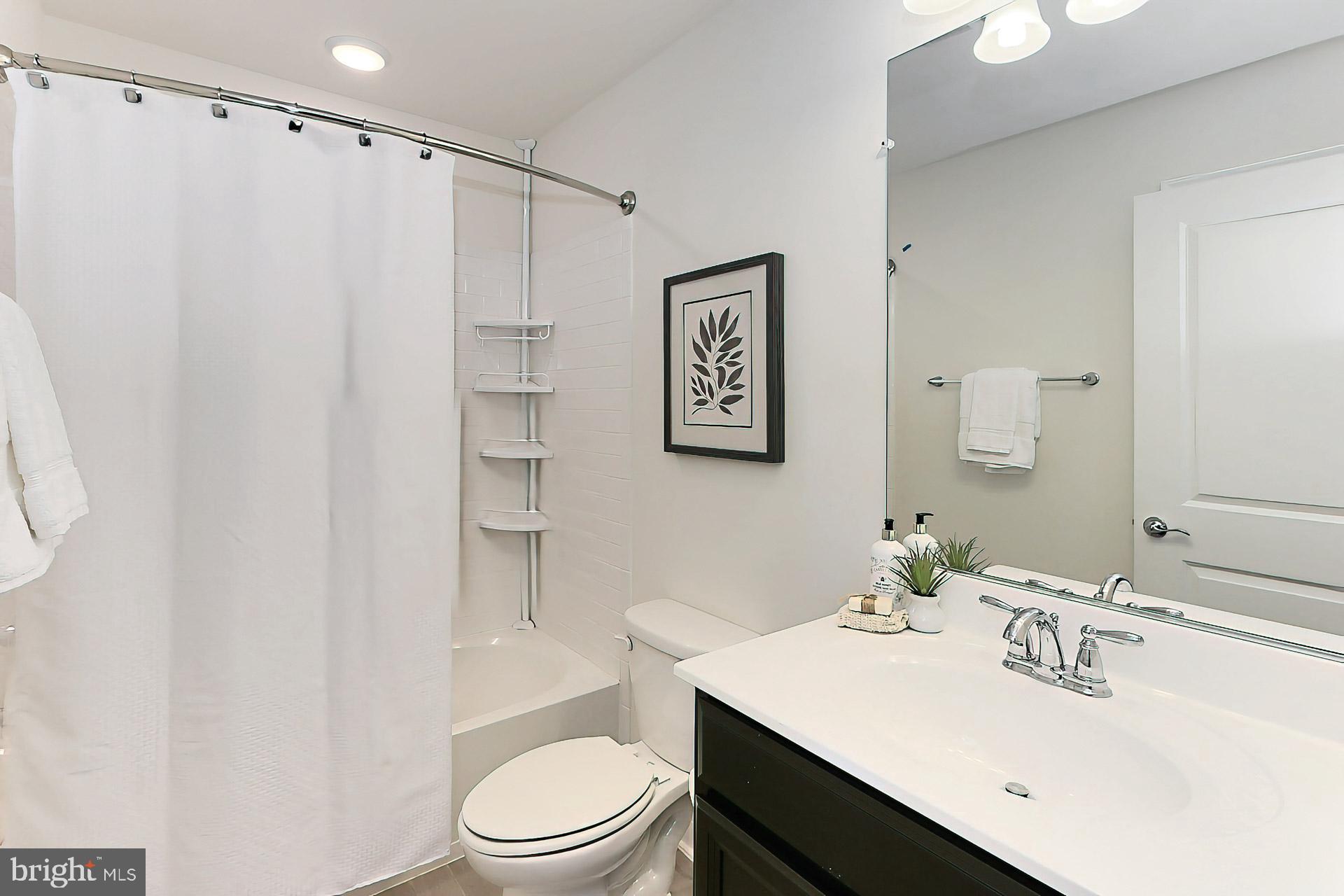 22574 Windsor Locks Square Ashburn, VA 20148 - Photo 29 of 51 Shared Hall Bath w/ Oversized Tile + Light in Show