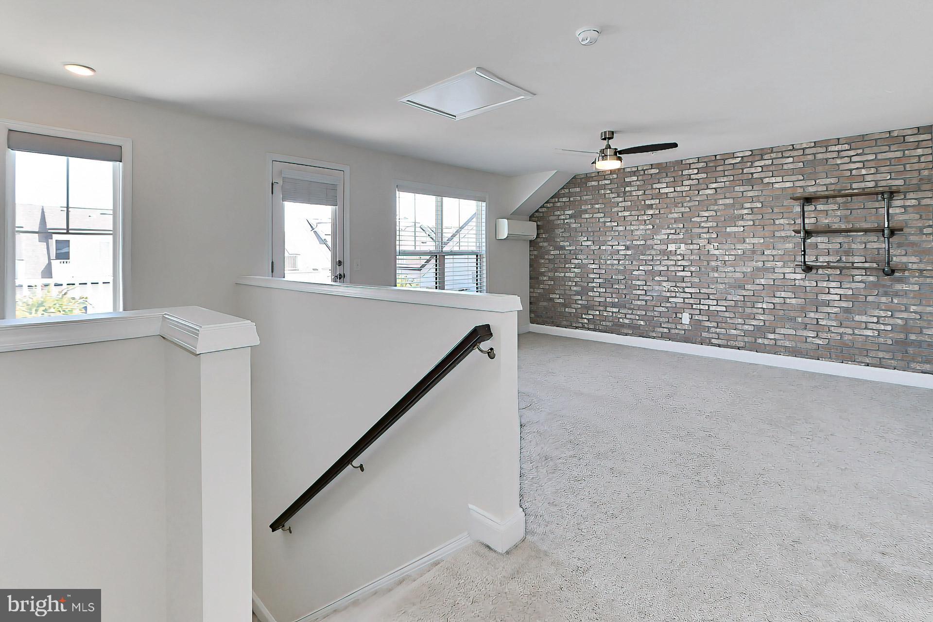 22574 Windsor Locks Square Ashburn, VA 20148 - Photo 33 of 51 Upper Level Loft w/ Brick Accent Wall + Shelving