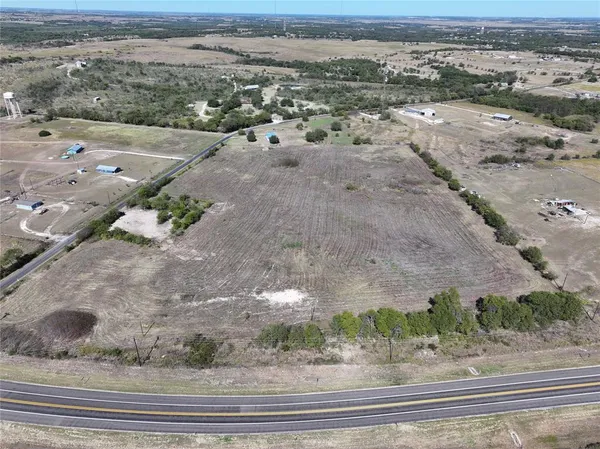 an aerial view of a houses with a yard