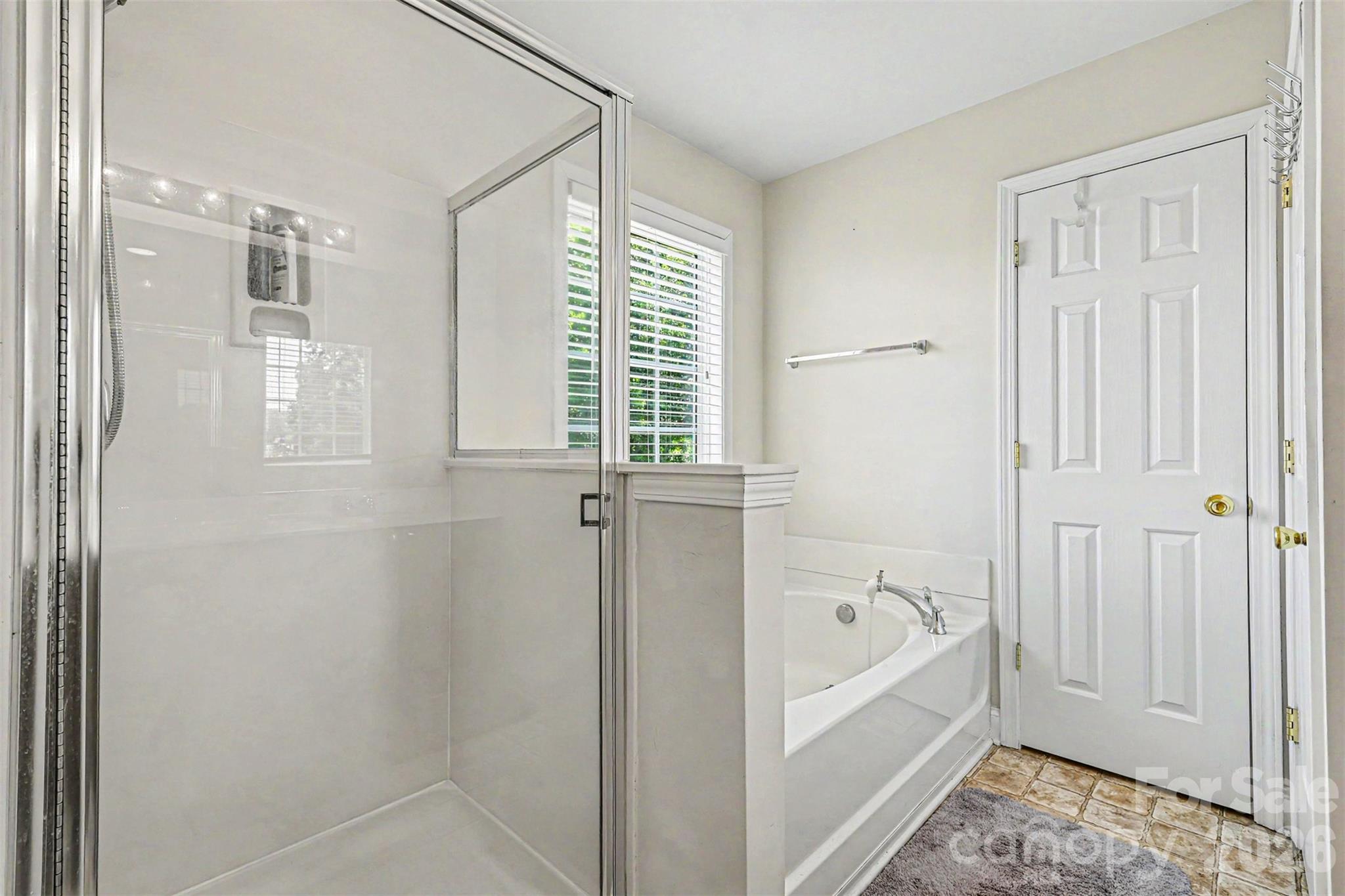 3035 Proverbs Court Monroe, NC 28110 - Photo 20 of 30 a bathroom with a bathtub and a shower
