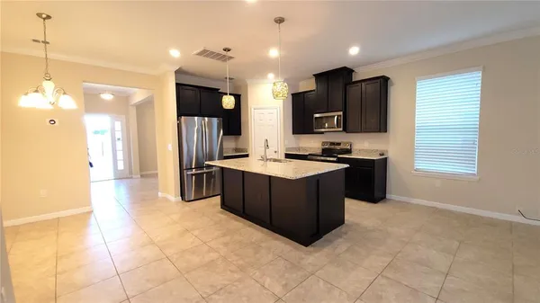 a kitchen with stainless steel appliances granite countertop a refrigerator and a stove