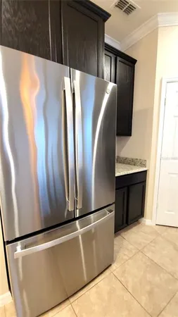 a view of kitchen with stainless steel appliances wooden floor and window