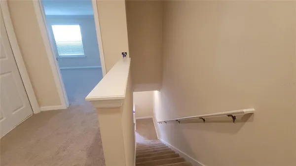 a view of a room with wooden floor and staircase