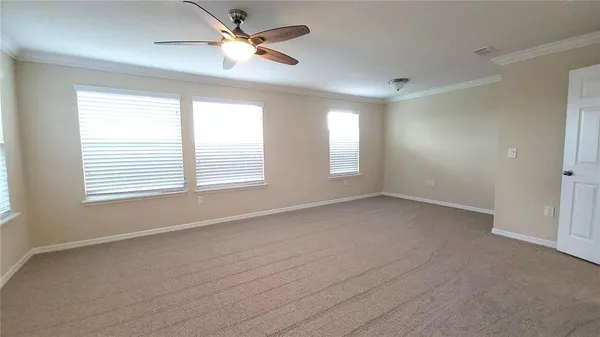 a view of room with a ceiling fan and window