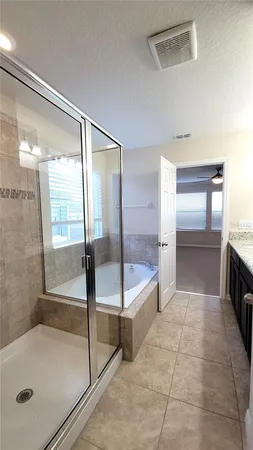 a bathroom with a tub and shower