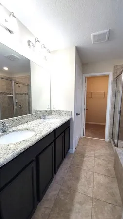 a bathroom with a granite countertop sink and mirror
