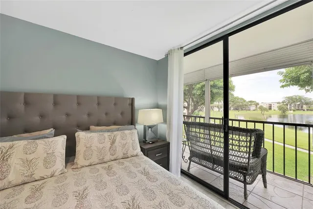 a view of a room with furniture and a large window