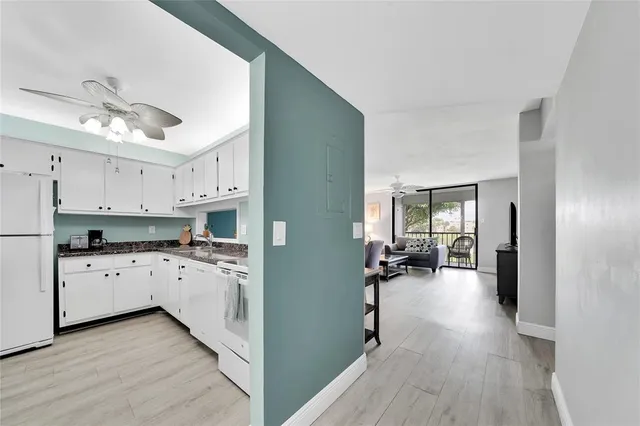 a kitchen with cabinets a sink and appliances