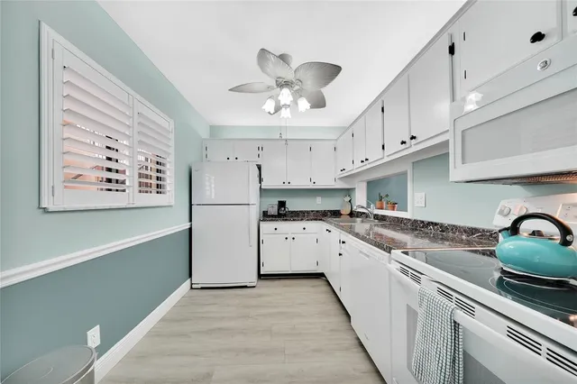 a kitchen with cabinets a sink and appliances