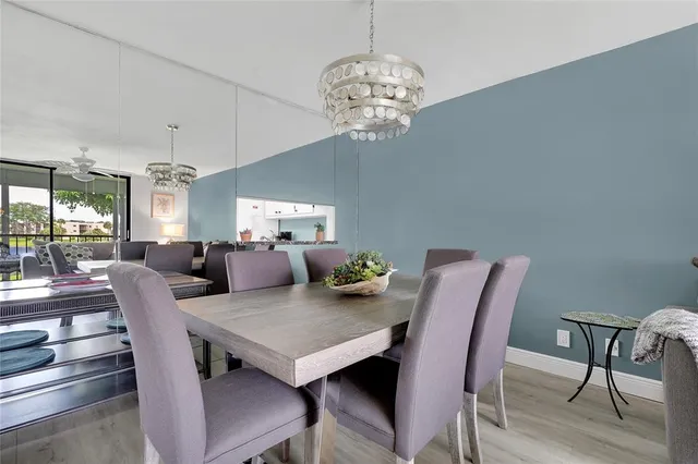a view of a dining room with furniture wooden floor and chandelier